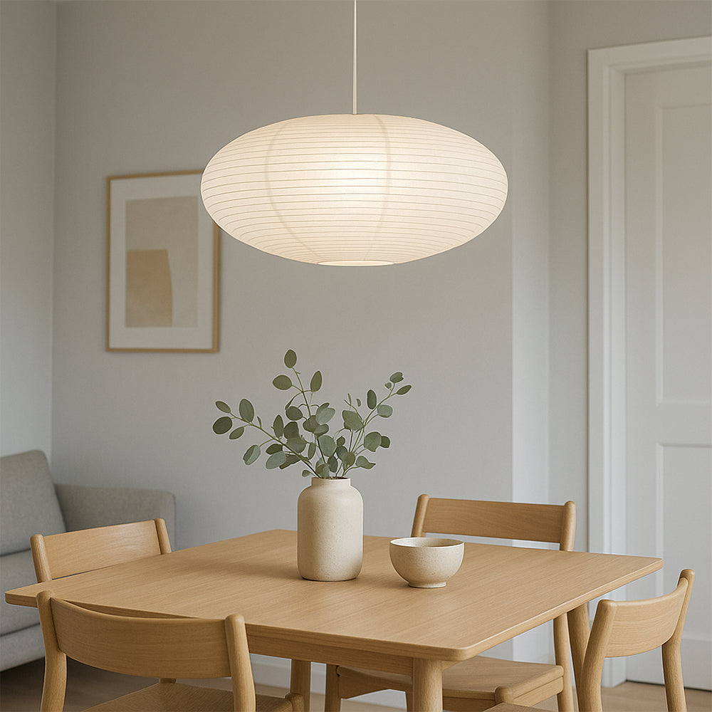 Dining room with wooden table, chairs, and a pendant light fixture.
